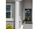 Covered front porch with stone accents, white column, decorative wreath, and 'home sweet home' door mat at 12739 Rainwashed Loop, Parrish, FL 34219