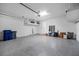 Spacious two car garage featuring bright lighting and epoxy flooring at 12739 Rainwashed Loop, Parrish, FL 34219