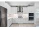 Updated kitchen features stainless steel appliances, white cabinets and light countertops at 12739 Rainwashed Loop, Parrish, FL 34219