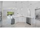 Bright kitchen offers a center island with stainless steel dishwasher and ample counter space at 12739 Rainwashed Loop, Parrish, FL 34219