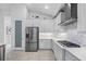 Modern kitchen with white cabinets, stainless steel appliances, and stylish backsplash at 12739 Rainwashed Loop, Parrish, FL 34219
