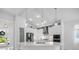 Bright kitchen features white cabinets, stainless steel appliances, pendant lighting, and ample counter space at 12739 Rainwashed Loop, Parrish, FL 34219