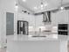 Stylish kitchen showcasing white cabinetry, stainless steel appliances, and a large center island at 12739 Rainwashed Loop, Parrish, FL 34219