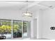 Bright living room with sliding glass doors that lead to a pool and patio area at 12739 Rainwashed Loop, Parrish, FL 34219