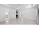 Large main bedroom with tile floors, and doorways to the bathroom and walk-in closet at 12739 Rainwashed Loop, Parrish, FL 34219