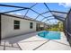 Backyard pool featuring a large screened in enclosure with outdoor seating at 12739 Rainwashed Loop, Parrish, FL 34219