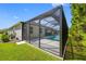 View of the backyard pool featuring a large screened in enclosure and lush landscaping at 12739 Rainwashed Loop, Parrish, FL 34219