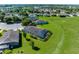 Backyard aerial view with a screened in pool enclosure, patio and lawn at 1280 Hill Flower Dr, Brooksville, FL 34604