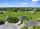 Backyard aerial view with a screened in pool enclosure, patio and lawn at 1280 Hill Flower Dr, Brooksville, FL 34604