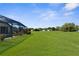 Large, well-maintained lawn, partially fenced in, providing ample space for outdoor activities at 1280 Hill Flower Dr, Brooksville, FL 34604