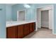 Bathroom featuring a double vanity with wood cabinets, tile flooring, and modern fixtures at 1280 Hill Flower Dr, Brooksville, FL 34604