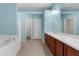 Light blue bathroom features a garden tub and double sink vanity at 1280 Hill Flower Dr, Brooksville, FL 34604