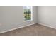 Neutral bedroom with carpet and a window providing natural light at 1280 Hill Flower Dr, Brooksville, FL 34604