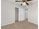 Neutral bedroom with carpet, ceiling fan, closet, and white doors at 1280 Hill Flower Dr, Brooksville, FL 34604