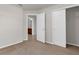 Bedroom featuring neutral carpet, an interior door, and a closet with doors at 1280 Hill Flower Dr, Brooksville, FL 34604