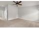 Bright bedroom featuring neutral carpet, ceiling fan, and base molding at 1280 Hill Flower Dr, Brooksville, FL 34604
