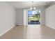 Bright dining area featuring tile floors, chandelier, and sliding glass doors to a backyard pool at 1280 Hill Flower Dr, Brooksville, FL 34604