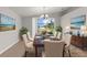 Traditional dining room with elegant chandelier, wall art, and a large sliding glass door at 1280 Hill Flower Dr, Brooksville, FL 34604