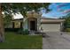 Traditional home exterior with an attached two-car garage at 1280 Hill Flower Dr, Brooksville, FL 34604