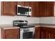 Stainless steel oven and microwave with dark wood cabinets and light countertops at 1280 Hill Flower Dr, Brooksville, FL 34604