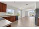Open kitchen with stainless steel appliances, dark wood cabinetry, and tile floors at 1280 Hill Flower Dr, Brooksville, FL 34604