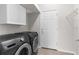 Laundry room featuring side by side washer and dryer and white cabinets at 1280 Hill Flower Dr, Brooksville, FL 34604
