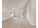 Open-plan living room with carpet, arched hallway, and great sunlight at 1280 Hill Flower Dr, Brooksville, FL 34604
