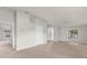 Bright living room with neutral carpet, white walls, and natural light streaming through the windows at 1280 Hill Flower Dr, Brooksville, FL 34604