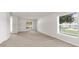 Neutral living room with large windows offering natural light, creating a welcoming space at 1280 Hill Flower Dr, Brooksville, FL 34604