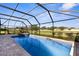 Relaxing screened-in pool area with an in-ground pool, spa and brick-paved deck at 1280 Hill Flower Dr, Brooksville, FL 34604
