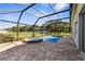 Screened-in pool with hot tub, brick pavers, and outdoor lighting at 1280 Hill Flower Dr, Brooksville, FL 34604