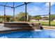 Close up view of the hot tub and water feature within screened pool at 1280 Hill Flower Dr, Brooksville, FL 34604