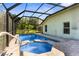 Backyard pool and spa in screened enclosure with brick paver patio and lush landscaping at 1280 Hill Flower Dr, Brooksville, FL 34604