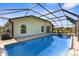 Back of the home with a screened-in pool and hot tub at 1280 Hill Flower Dr, Brooksville, FL 34604