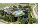 Stunning aerial view of community pool, clubhouse, pond with fountain, and recreation area at 12904 Prestwick Dr, Riverview, FL 33579