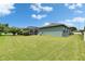 Spacious backyard with well-maintained lawn and green exterior of the home at 12904 Prestwick Dr, Riverview, FL 33579