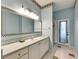 Bright bathroom featuring a large mirror with unique accents and blue walls at 12904 Prestwick Dr, Riverview, FL 33579