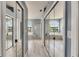 Hallway leading to bathroom featuring dual closets and arched windows over the tub at 12904 Prestwick Dr, Riverview, FL 33579