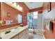 Cozy bathroom with single sink vanity, framed mirror, and tub-shower combination at 12904 Prestwick Dr, Riverview, FL 33579