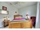 Inviting bedroom featuring a wood bed frame, ceiling fan, and cozy reading chair at 12904 Prestwick Dr, Riverview, FL 33579