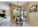 Cozy breakfast nook with glass table, stylish chairs, and views of the lanai at 12904 Prestwick Dr, Riverview, FL 33579