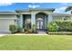 Charming front entrance with double doors, manicured garden, and inviting walkway at 12904 Prestwick Dr, Riverview, FL 33579