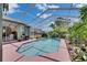Screened in pool area with a light blue in-ground pool surrounded by lush greenery at 12904 Prestwick Dr, Riverview, FL 33579