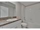 Bathroom boasts granite countertops, a shower-tub combo, and tile flooring at 14047 Weddington Ter, Hudson, FL 34669