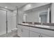 Bathroom featuring double sinks with granite countertop and glass-enclosed shower at 14047 Weddington Ter, Hudson, FL 34669
