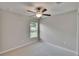 Bedroom is well-lit by a window and has a ceiling fan with carpet at 14047 Weddington Ter, Hudson, FL 34669
