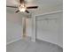 Bedroom includes neutral tones, carpet, a ceiling fan, and a closet adjacent to the hallway at 14047 Weddington Ter, Hudson, FL 34669