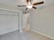 Bedroom includes neutral tones, carpet, a ceiling fan, and a closet adjacent to the hallway at 14047 Weddington Ter, Hudson, FL 34669
