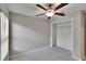 Bedroom boasts neutral tones, carpet, and a ceiling fan, complemented by a closet at 14047 Weddington Ter, Hudson, FL 34669