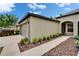 View of the home's side showing an attached two-car garage and arched entrance at 14047 Weddington Ter, Hudson, FL 34669